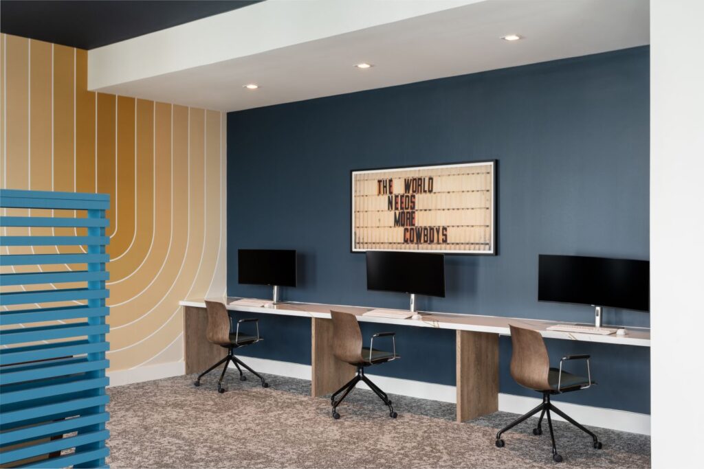 REV Student Living Computer Lab with Curved Monitors and Sign